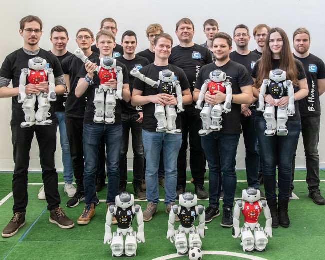 B-Human team members and robots of the 2019 season.